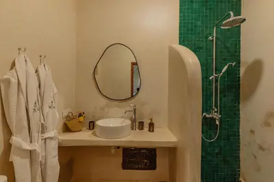 a bathroom with a sink and a shower with a mirror at Riad Senja in Marrakech