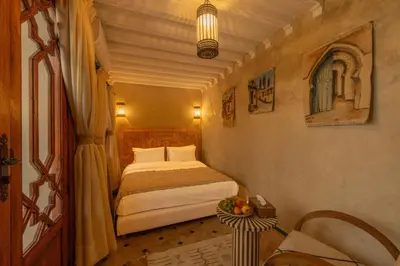 a small bedroom with a bed in a room at Riad Senja in Marrakech