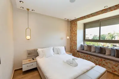 a bedroom with a large white bed and a window at Villa Golf Marrakech in Marrakech