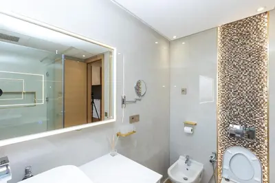a bathroom with a sink and a toilet and a mirror at Villa Golf Marrakech in Marrakech