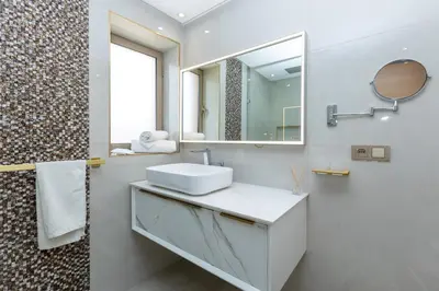 a white bathroom with a sink and a mirror at Villa Golf Marrakech in Marrakech