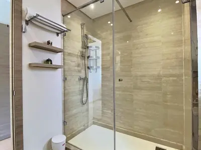 a shower with a glass door in a bathroom at Jade Prestigia Golf in Marrakech