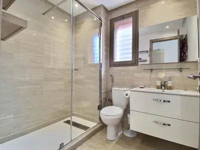 a bathroom with a shower and a toilet and a sink at Jade Prestigia Golf in Marrakech