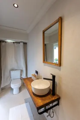 a bathroom with a sink and a toilet and a mirror at Riad Tawja in Marrakech