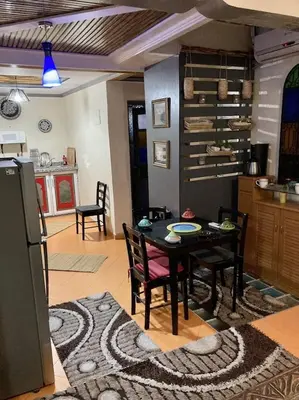 a kitchen and dining room with a table and chairs at Dar Diego des appartements au Centre de la Médina in Marrakech