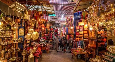 a shop with people walking through a market with items at Dar Diego des appartements au Centre de la Médina in Marrakech