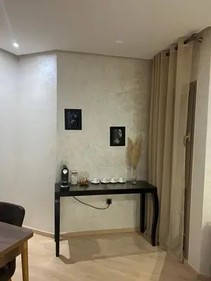 a living room with a table in the corner at Prestigia marrakech in Marrakech
