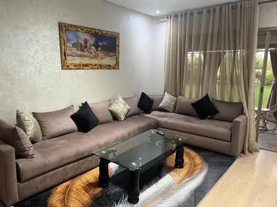 a living room with a couch and a coffee table at Prestigia marrakech in Marrakech