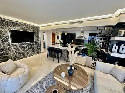 a living room with a couch and a table at Ultra-Luxury 2-Bedroom Apartment in City Center Atlas View in Marrakech