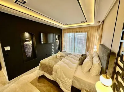 a bedroom with a large bed and a window at Ultra-Luxury 2-Bedroom Apartment in City Center Atlas View in Marrakech