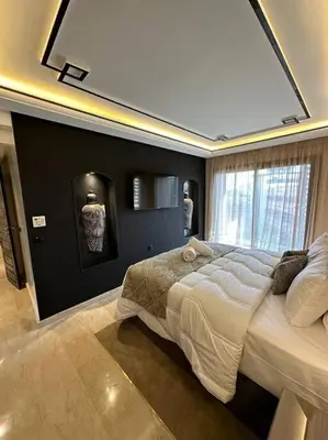 a bedroom with a large bed and a large window at Ultra-Luxury 2-Bedroom Apartment in City Center Atlas View in Marrakech