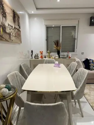 a dining room with a white table and chairs at Appart à Marrakech,spacieux, calme et propre in Marrakech