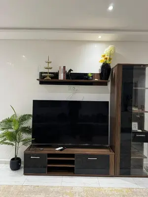 a large entertainment center with a large flat screen tv at Appart à Marrakech,spacieux, calme et propre in Marrakech