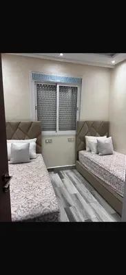 a bedroom with two beds and a window at Appart à Marrakech,spacieux, calme et propre in Marrakech