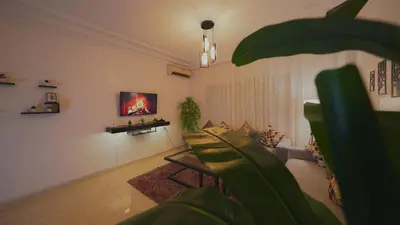 a living room with a couch and a tv on the wall at Modern Apartment in Centre of Marrakech For Friends & Families in Marrakech
