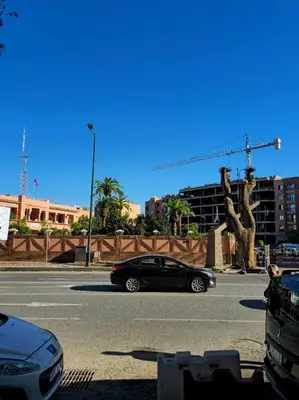 a black car is driving down a street at Modern Apartment in Centre of Marrakech For Friends & Families in Marrakech