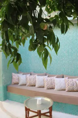 a room with a couch with a table and a tree at Riad Emberiza Sahari in Marrakech