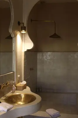 a bathroom with a sink and a mirror at Riad Emberiza Sahari in Marrakech