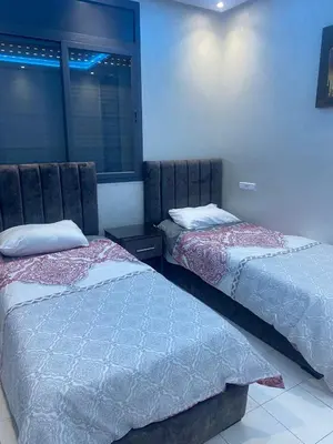 two beds sitting next to each other in a room at L'hivernage in Marrakech
