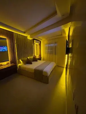 a bedroom with a bed in a room with lights at Bel Appartement Hivernage Gueliz in Marrakech