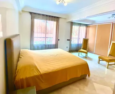 a bedroom with a yellow bed and a chair at Yasmine Majorelle Marrakech in Marrakech