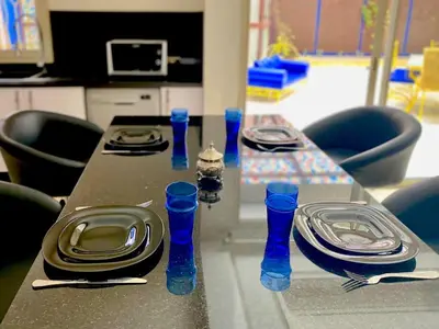 a table with plates and blue bottles on it at Yasmine Majorelle Marrakech in Marrakech