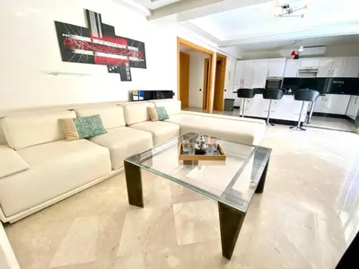 a living room with a couch and a glass table at Yasmine Majorelle Marrakech in Marrakech