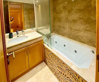 a bathroom with a tub and a sink at Yasmine Majorelle Marrakech in Marrakech