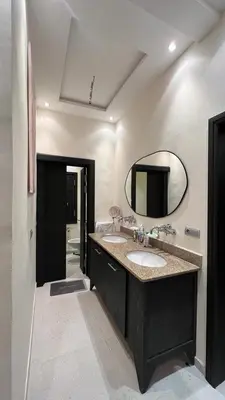 a bathroom with two sinks and a mirror at Ourika immoblier in Marrakech