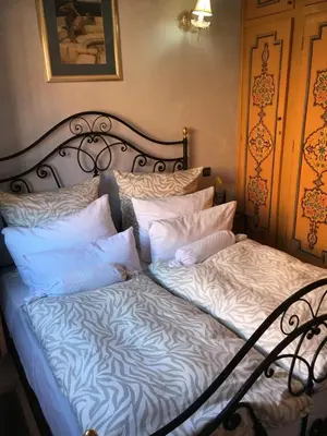 a bed with white sheets and pillows at Zina in Marrakech