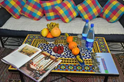a table with fruits and bottles on top of a couch at Zina in Marrakech