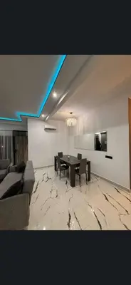 a living room with a table and a couch at Apparemment chic in Marrakech