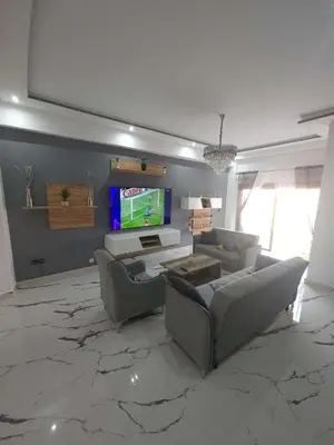 a living room with two couches and a tv at Apparemment chic in Marrakech