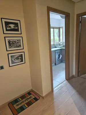 a hallway of a house with a door to a laundry room at Bel appartement avec piscine et jardin in Marrakech