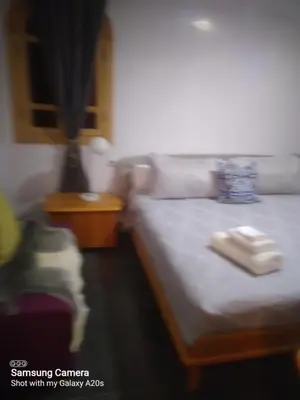 a bedroom with a bed and a table with towels on it at Ykar in Marrakech