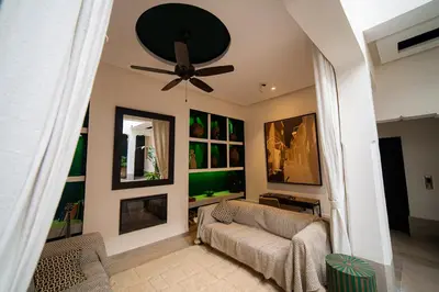 a living room with a ceiling fan and a couch at Riad Sabrawa in Marrakech