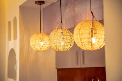 a group of lights hanging from a wall at Magnifique appart Moderne à Gueliz in Marrakech