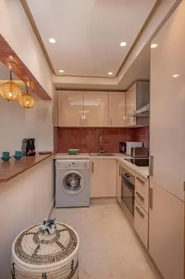 a kitchen with a washing machine and a dishwasher at Magnifique appart Moderne à Gueliz in Marrakech