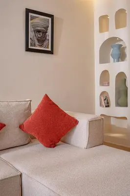 a living room with a couch with two red pillows at Magnifique appart Moderne à Gueliz in Marrakech