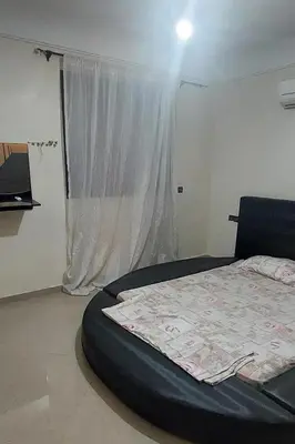 a bedroom with a large bed with a window at دوبلكس في مراكش in Marrakech