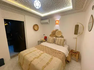 a bedroom with a bed and a ceiling at Douria FARAH, Authentique in Marrakech