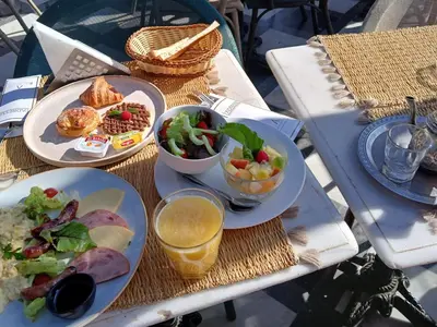 a table with two plates of food and a salad at Douria FARAH, Authentique in Marrakech