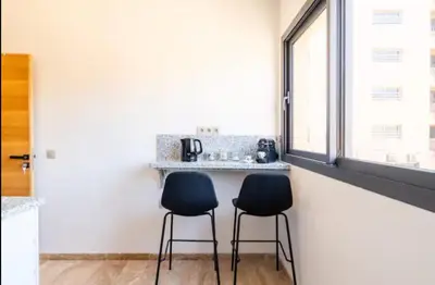 two chairs sitting next to a counter in a kitchen at Appartement gueliz in Marrakech