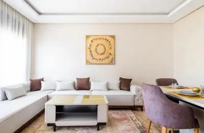 a living room with a white couch and a table at Appartement gueliz in Marrakech