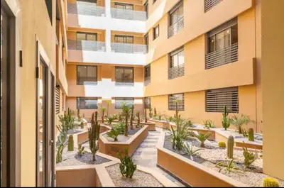 an apartment building with plants in the courtyard at Appartement gueliz in Marrakech