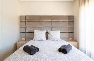 a bedroom with a bed with two towels on it at Appartement gueliz in Marrakech