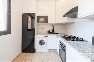 a kitchen with a washer and dryer in it at Appartement gueliz in Marrakech