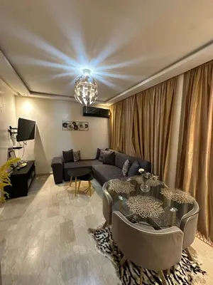 a living room with a couch and a table at Yany cosy appartement in Marrakech