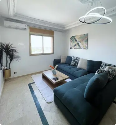 a living room with a blue couch and a table at New nice apartment city center swimming pool wifi in Marrakech