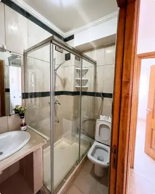 a bathroom with a glass shower and a toilet at New nice apartment city center swimming pool wifi in Marrakech